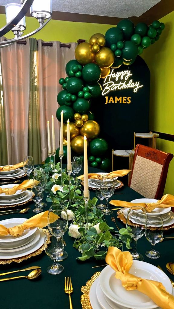 WhatsApp Image 2026-06-18 at 13.47.52 Green and gold birthday tablescape with balloon backdrop and Happy Birthday James sign.